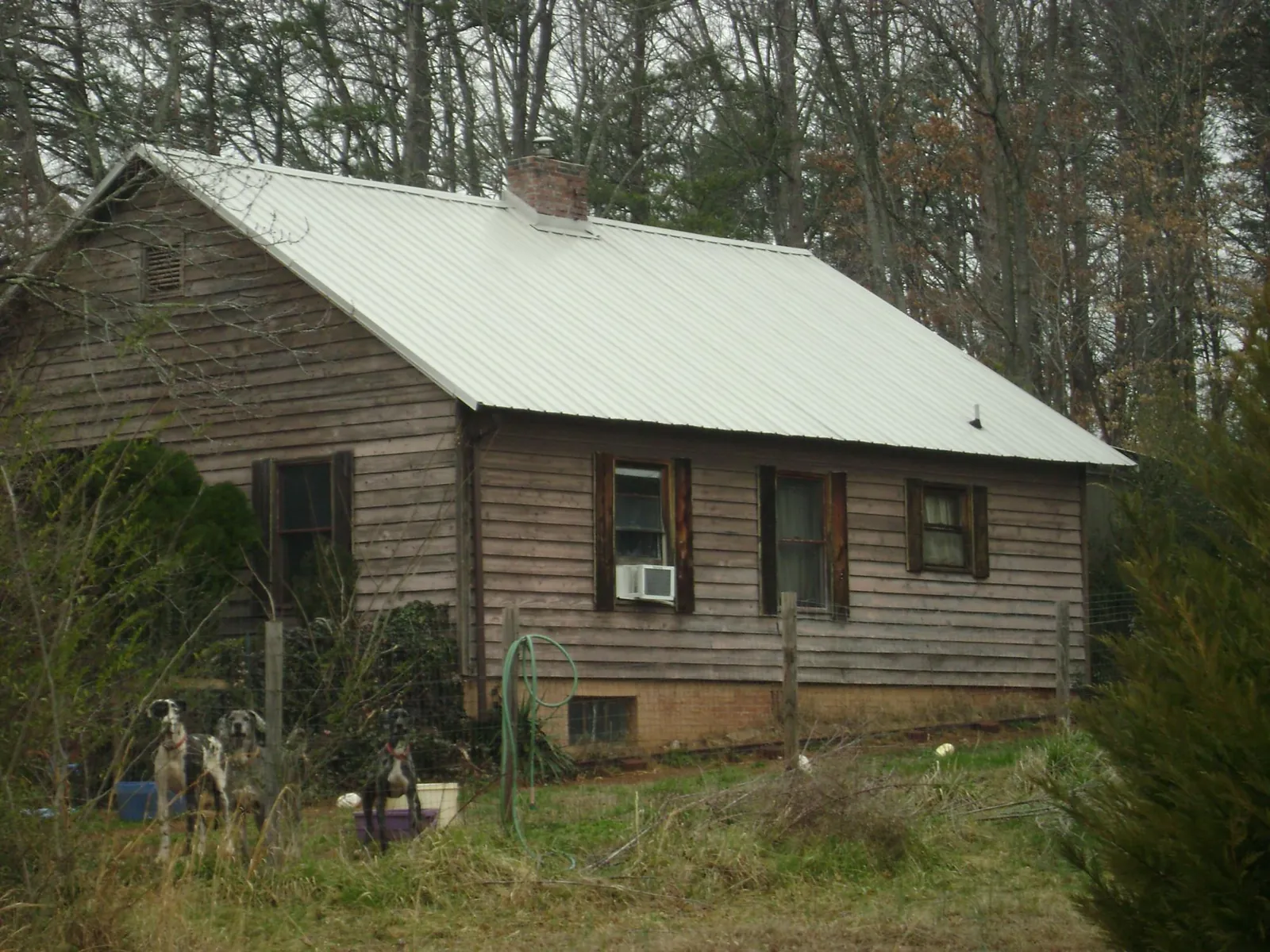 White metal roof on an old wood sided farmhouse, from a Asphalt Shingle Roof Repair job in Saint Charles